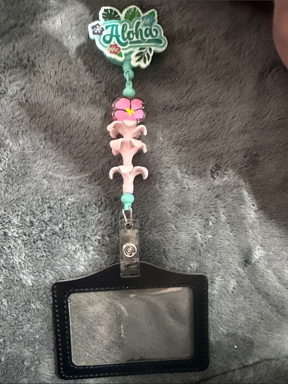 Aloha Badge Reel Accented with Pink Puakenikeni Flowers and Hibiscus Charm